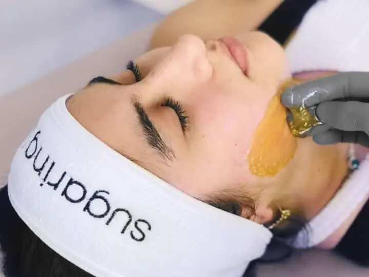 Woman lays back with her eyes closed at a spa