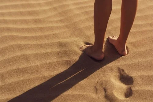 feet standing in sand