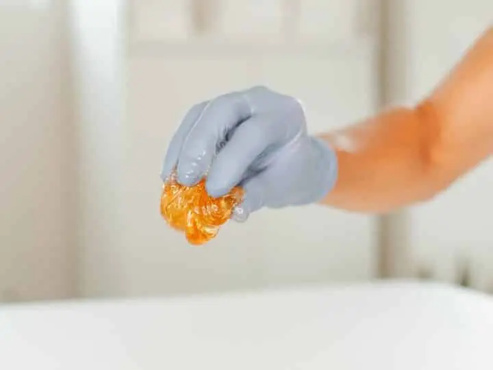 Wax help by gloved hand